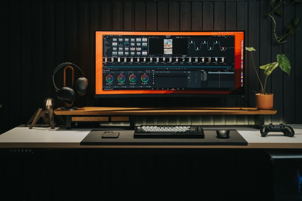 Sleek home office with a powerful video editing workstation and gaming console, perfect for creators.